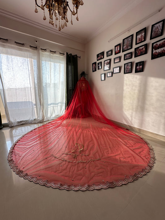 Niyati : A red cathedral length with hand beaded Ganesha on back