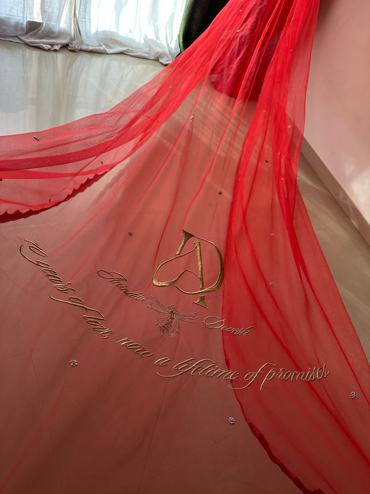 Niyati : A red cathedral length with hand beaded Ganesha on back